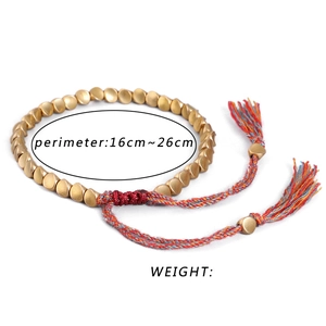 Pulsera étnica tejida a mano con cuentas de latón y borlas coloridas ajustables