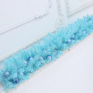 Artificial light blue Christmas garland with decorative baubles for festive room decor