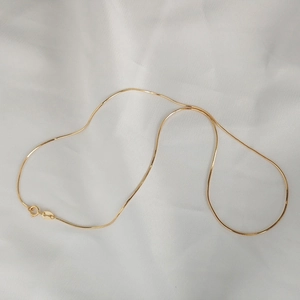 Detail of minimalist gold 925 sterling silver snake chain with S925 hallmark