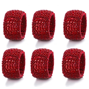 Set of 6 bright red beaded napkin rings arranged in a neat professional 2x3 grid