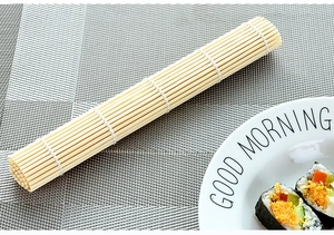 Detail of a natural bamboo sushi rolling mat with cotton thread weaving and sushi rolls