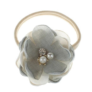 Detail of floral nylon headband for girls featuring gray fabric flower with pearl center