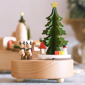 Wooden Christmas music box featuring hand-painted reindeer and snowmen on revolving base