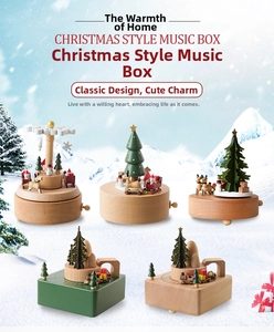 Detailed view of five handcrafted wooden Christmas music boxes with rotating festive motifs