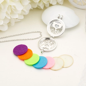 Detail of heart-shaped LOVE aroma diffuser necklace with colorful felt pads set