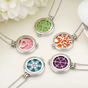 Set of five hollow stainless steel aromatherapy lockets with colorful essential oil pads
