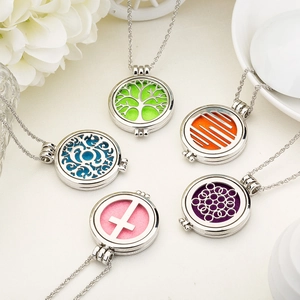 Detail of five hollow aromatherapy necklaces with colorful felt pads and polished finish