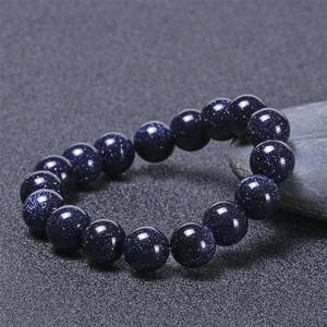 Detailed view of natural blue goldstone beads with galaxy-like shimmering star effects