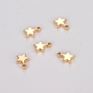 Five bright gold star-shaped DIY pendants with integrated rings on a grey background