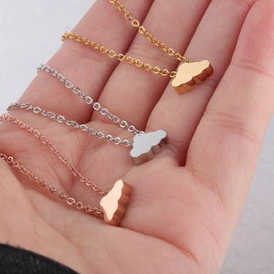 Three minimalist cloud pendant necklaces in gold, silver and rose gold mirror finish