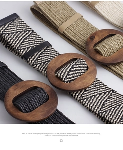 Detail of woven straw belts in multiple colors with large round wooden buckles