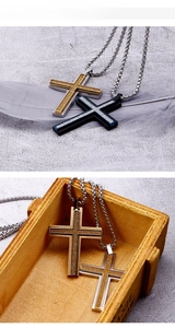 Macro shot of double-layer cross pendant with frosted texture and thick steel link chain