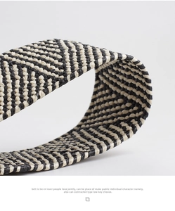 Detailed view of black and white woven straw belt featuring a premium twill pattern