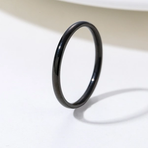 Minimalist slim black polished stainless steel ring shown from a 45-degree angle