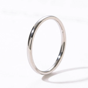 Macro shot of minimalist polished stainless steel ring with a smooth silver-tone finish