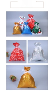 Close-up of metallic Christmas drawstring gift bags with Santa and snowflake patterns