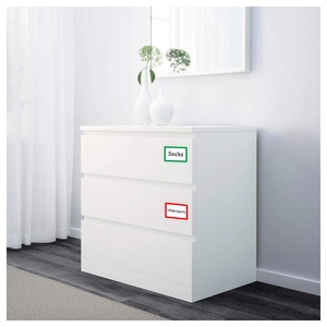 Self-adhesive cartoon name labels for socks and underpants on white drawer cabinet