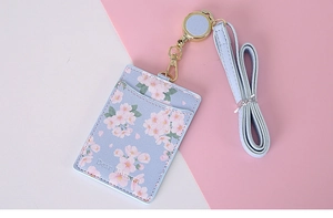 Detail of light blue cherry blossom PU leather ID card holder with retractable lanyard