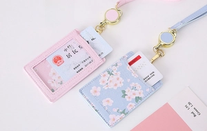 Detail of cross-grain PU leather card holder with retractable lanyard and clear ID window