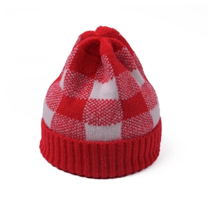 Close-up of red and white checkerboard knit beanie with ribbed fold-over cuff detail