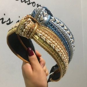 Close-up of bohemian sequin and pearl wide knotted headbands with luxury rhinestones