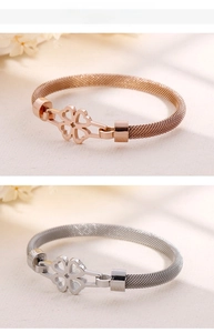 Detail of Milanese mesh steel bracelets with hollow clover clasps in silver and rose gold