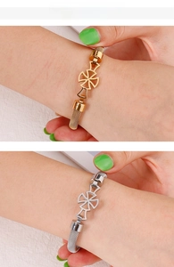 Detailed view of mesh chain bracelets in gold and silver with hollow cross charms