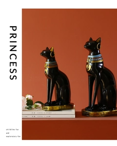 Pair of black and gold Egyptian Bastet cat statues on books with hieroglyphic details