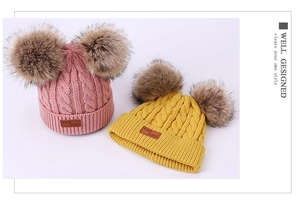 Detailed knit texture of yellow and pink winter beanies with soft double faux fur pom poms