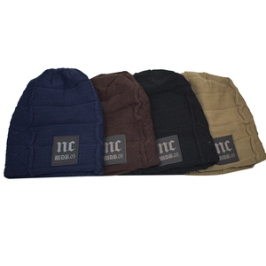 Men's winter fleece lined knit hats in navy, brown, black and khaki with leather patch