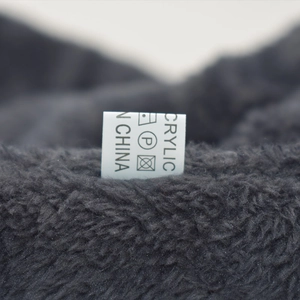Detail shot of the warm fleece lining and acrylic material care label for winter hat