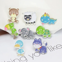 Detailed view of eight colorful cartoon animal enamel pins including bear and dinosaur