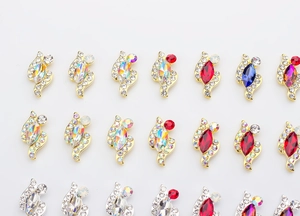 Detailed view of horse-eye K9 crystals in gold and silver settings for nail art decoration