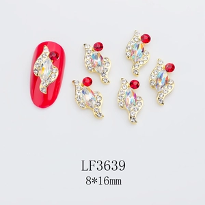 Macro detail of marquis-cut colorful nail art alloy charms with red crystal accents