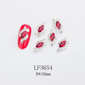 Detail view of 8x16mm red marquise nail gems with silver settings and rhinestones