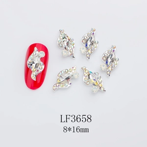 Detail view of silver alloy horse-eye rhinestones on red nails and single units