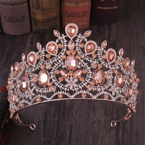 Baroque rose gold crown with champagne rhinestones on a vintage book background
