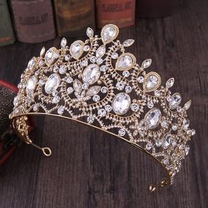 Close-up of Baroque gold bridal crown with sparkling crystal rhinestones on a vintage table