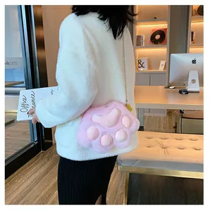 Detail of pink plush cat paw crossbody bag with soft faux fur and gold chain strap