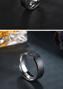 Detailed view of men's stainless steel ring with black knurled texture and silver edges