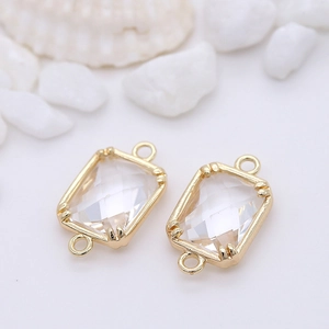 Macro shot of 14K gold plated rectangular glass connectors with dual loops for jewelry DIY