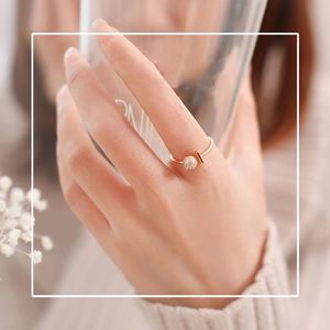 Adjustable gold open ring featuring a micro-paved crystal ball and minimalist geometric design
