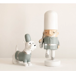 Detailed macro view of gray soldier doll and white terrier dog resin figurine set