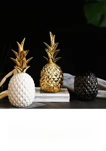 Close-up of ceramic pineapple decor with golden electroplated leaves and diamond texture