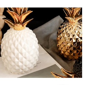 Macro detail of geometric ceramic pineapple decor with metallic gold electroplated leaves