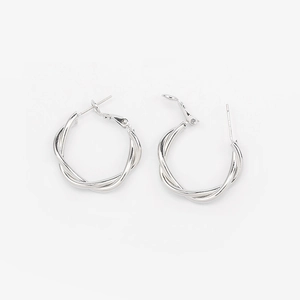 Macro detail of silver twisted hoop earrings with 925 sterling silver pins on white back