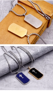 Detailed view of stainless steel dog tag pendants in silver, gold, blue and black finishes
