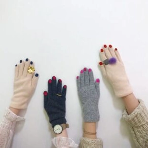 Detailed view of colorful gradient knit gloves in various neutral and dark shades