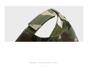 Detail of adjustable velcro strap and jungle camouflage fabric on cotton baseball cap