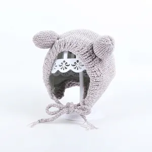 Detailed knit texture of a warm winter baby hat with cute bear ears and chin strap